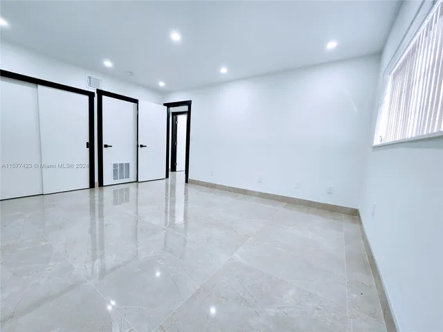 an entryway in a hall with a window