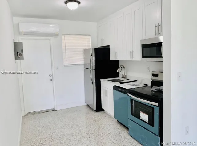 a kitchen with stainless steel appliances granite countertop a stove and a refrigerator