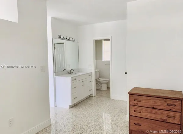 a bathroom with a double vanity sink a mirror and a bathtub