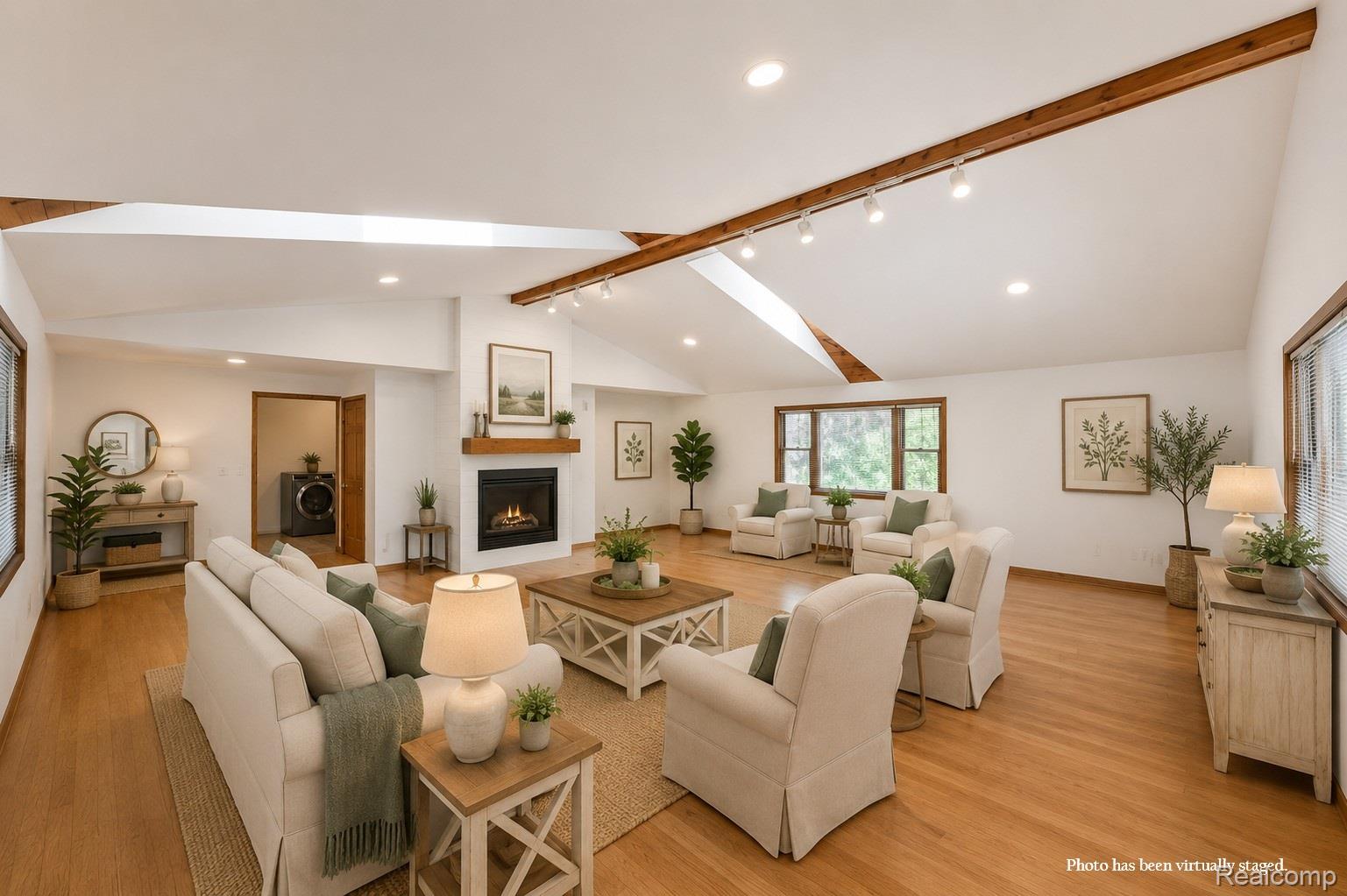 10201 Washburn Road Goodrich, MI 48438 - Photo 22 of 85 Vaulted ceiling with exposed wood beams, wood-finish flooring, built-in fireplace with wood mantel, recessed lighting, and multiple windows