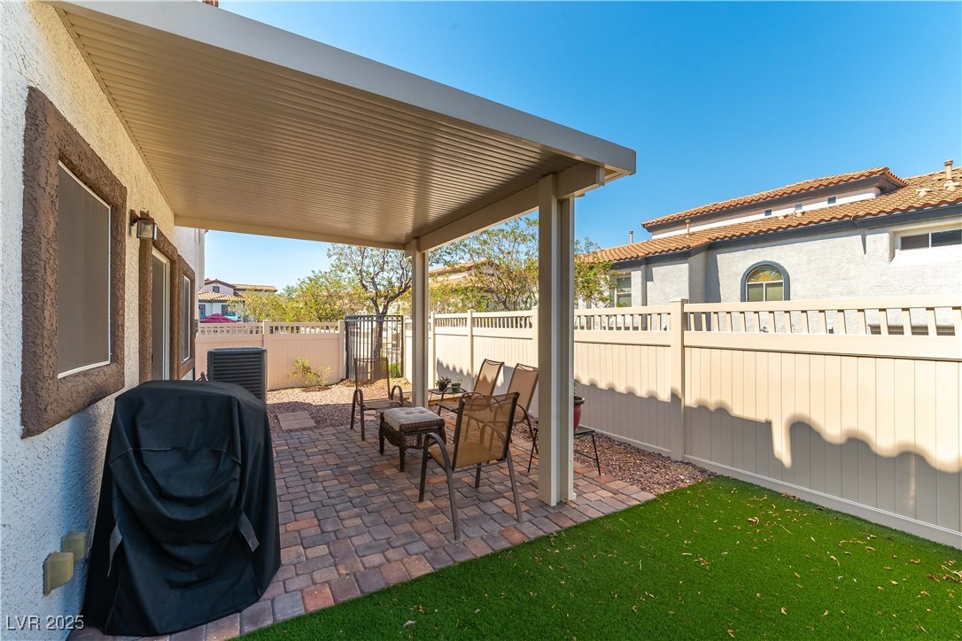 1109 Tropical Star Lane, Unit 1 Henderson, NV 89002 - Photo 26 of 41 Largest Lot-Covered Paver Patio with Synthetic Grass Space