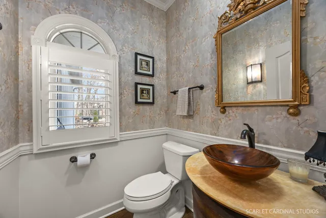 a bathroom with a toilet a sink and mirror
