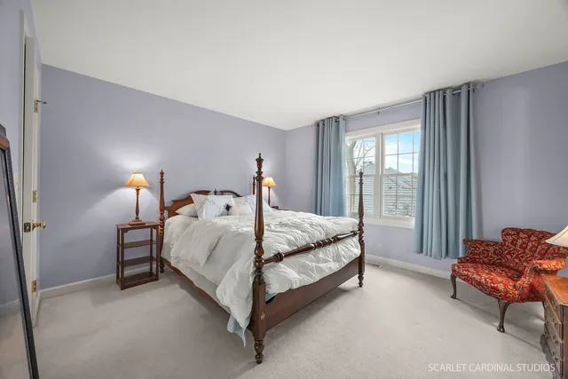 a bed sitting in a bedroom next to a window