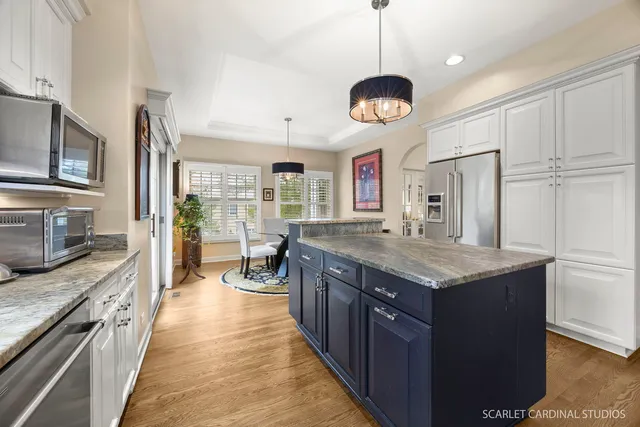 a large kitchen with stainless steel appliances granite countertop a stove oven and a refrigerator