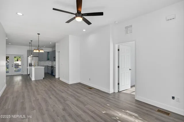 a view of a kitchen with wooden floor and a sink