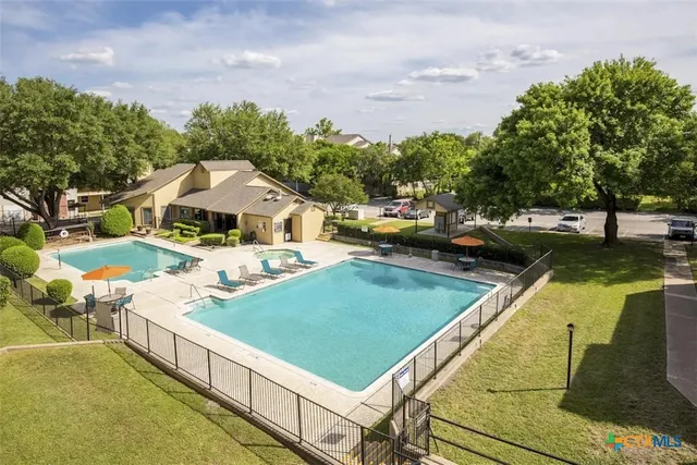 a view of a patio with chairs and a table