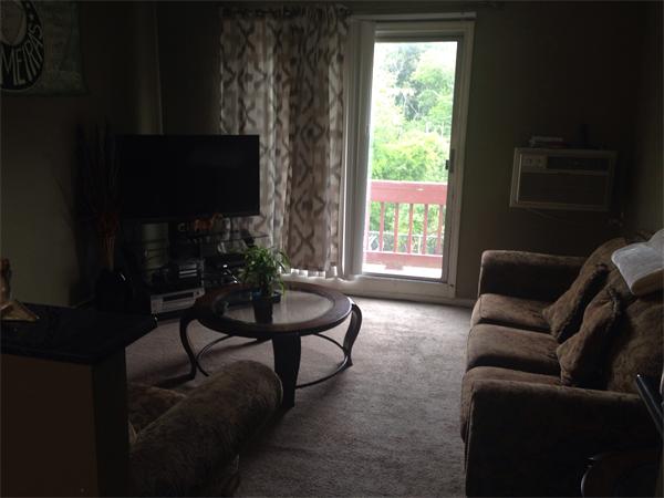 116 Boston Post Road East, Unit 204 Marlborough, MA 01752 - Photo 3 of 7 a living room with furniture a flat screen tv and a window