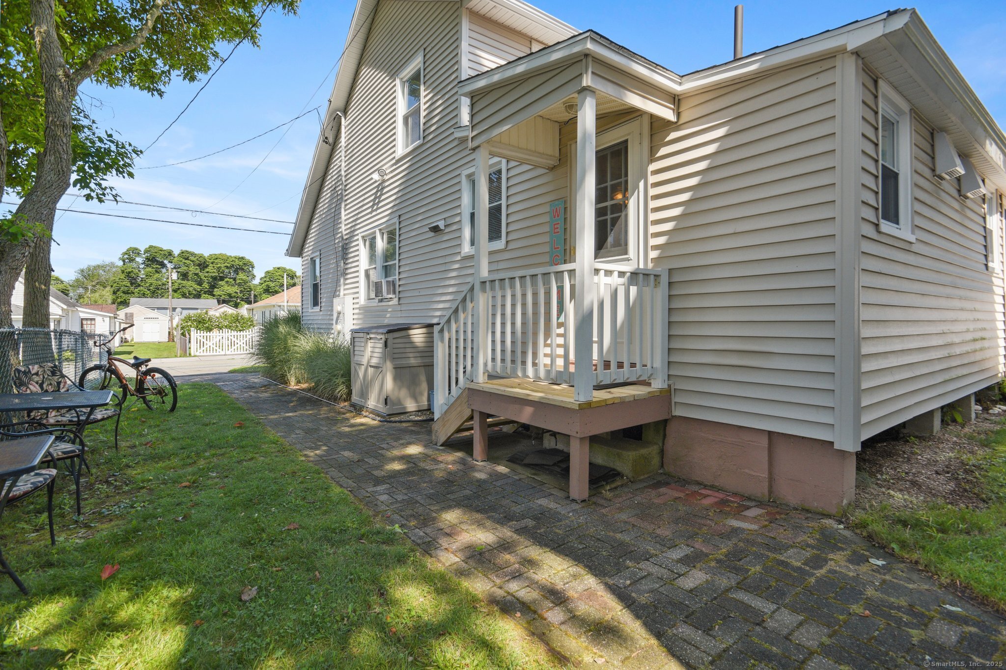 30 Hartford Avenue, Unit B Old Saybrook, CT 06475 - Photo 19 of 23 a backyard of a house with table and chairs