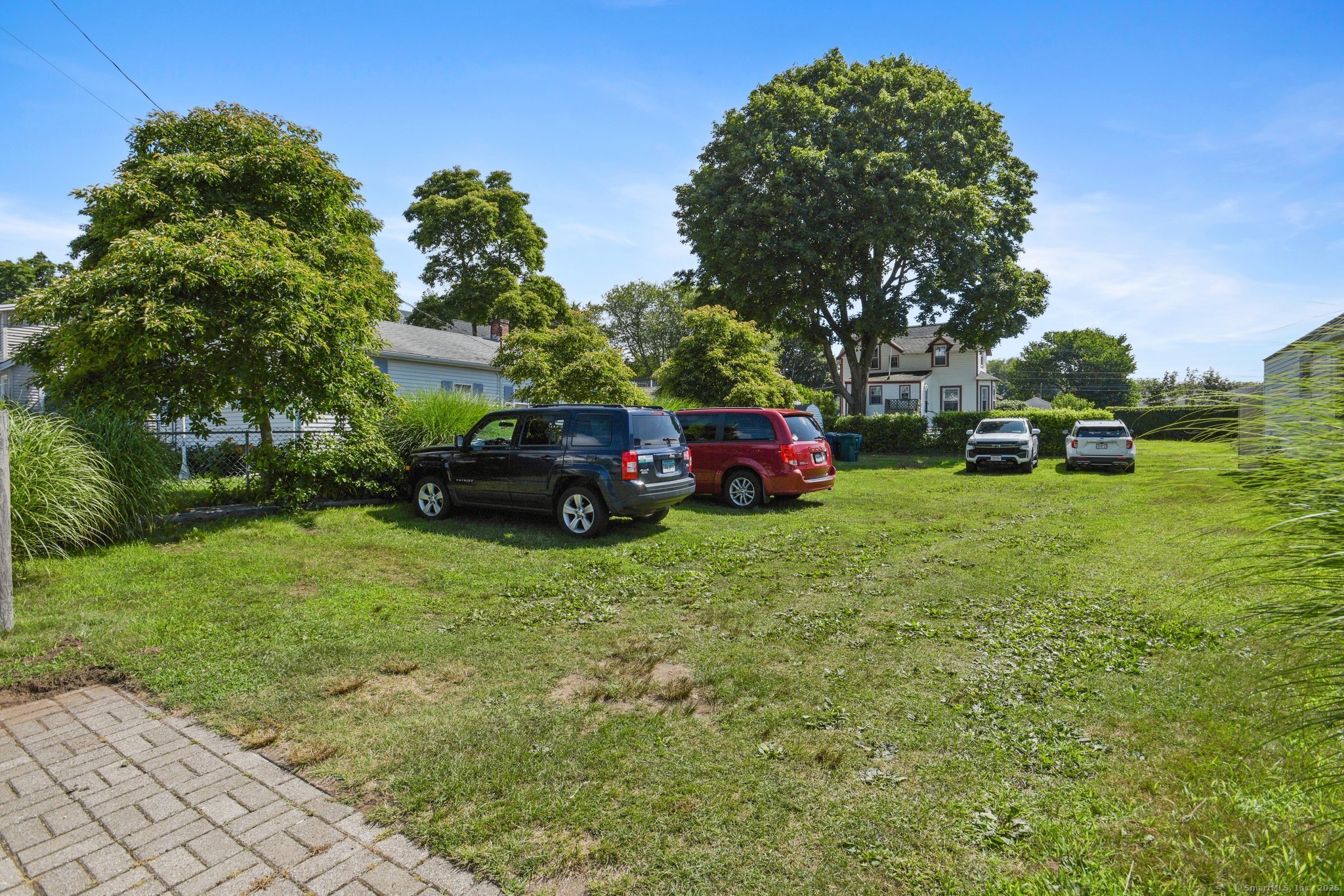 30 Hartford Avenue, Unit B Old Saybrook, CT 06475 - Photo 23 of 23 a view of a trees in front of a house with a big yard