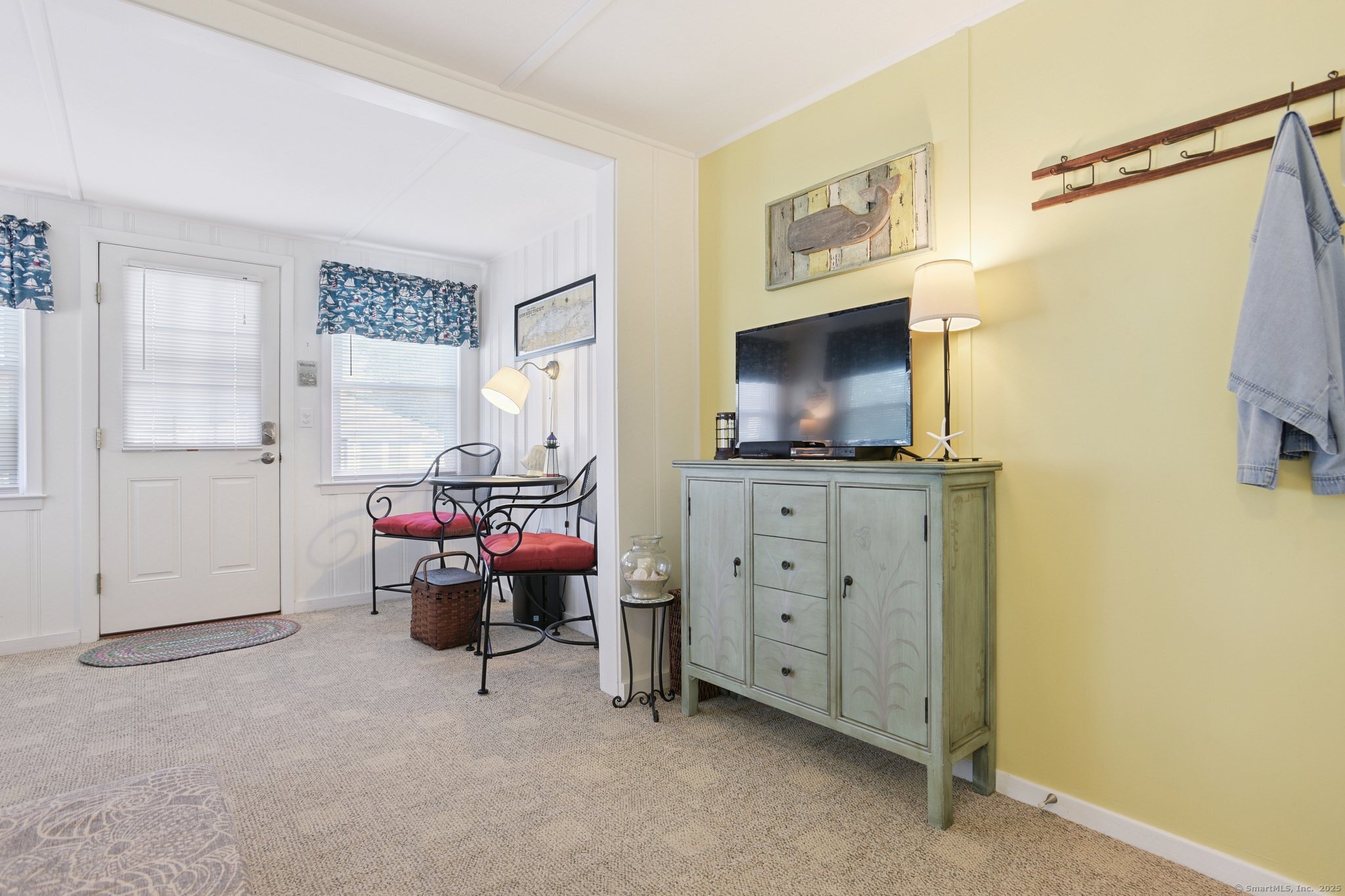 30 Hartford Avenue, Unit B Old Saybrook, CT 06475 - Photo 8 of 23 a living room with furniture and a flat screen tv