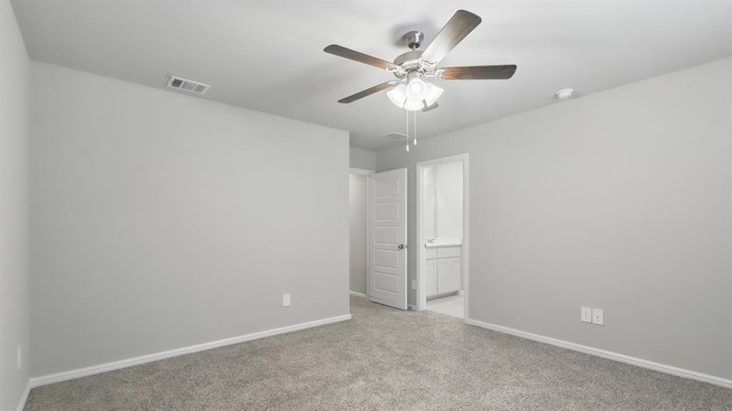 3149 Maple Orch Lane Fort Worth, TX 76140 - Photo 22 of 39 an empty room with a chandelier fan and a ceiling fan