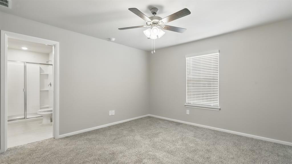 3149 Maple Orch Lane Fort Worth, TX 76140 - Photo 23 of 39 an empty room with a window and a fan