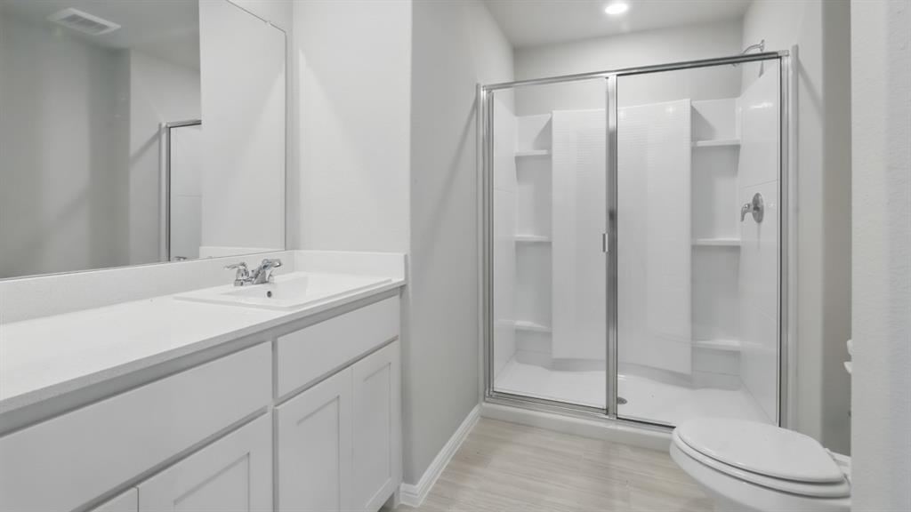 3149 Maple Orch Lane Fort Worth, TX 76140 - Photo 24 of 39 a bathroom with a shower toilet and sink