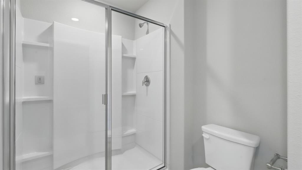 3149 Maple Orch Lane Fort Worth, TX 76140 - Photo 25 of 39 a bathroom with a shower and toilet