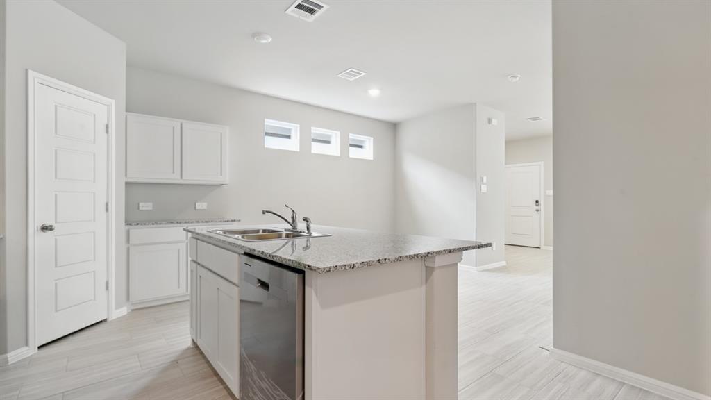 3149 Maple Orch Lane Fort Worth, TX 76140 - Photo 2 of 39 a kitchen with stainless steel appliances granite countertop a sink and a refrigerator