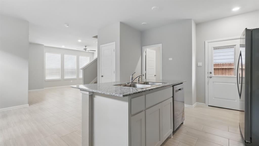 3149 Maple Orch Lane Fort Worth, TX 76140 - Photo 3 of 39 a bathroom with a granite countertop sink and a mirror
