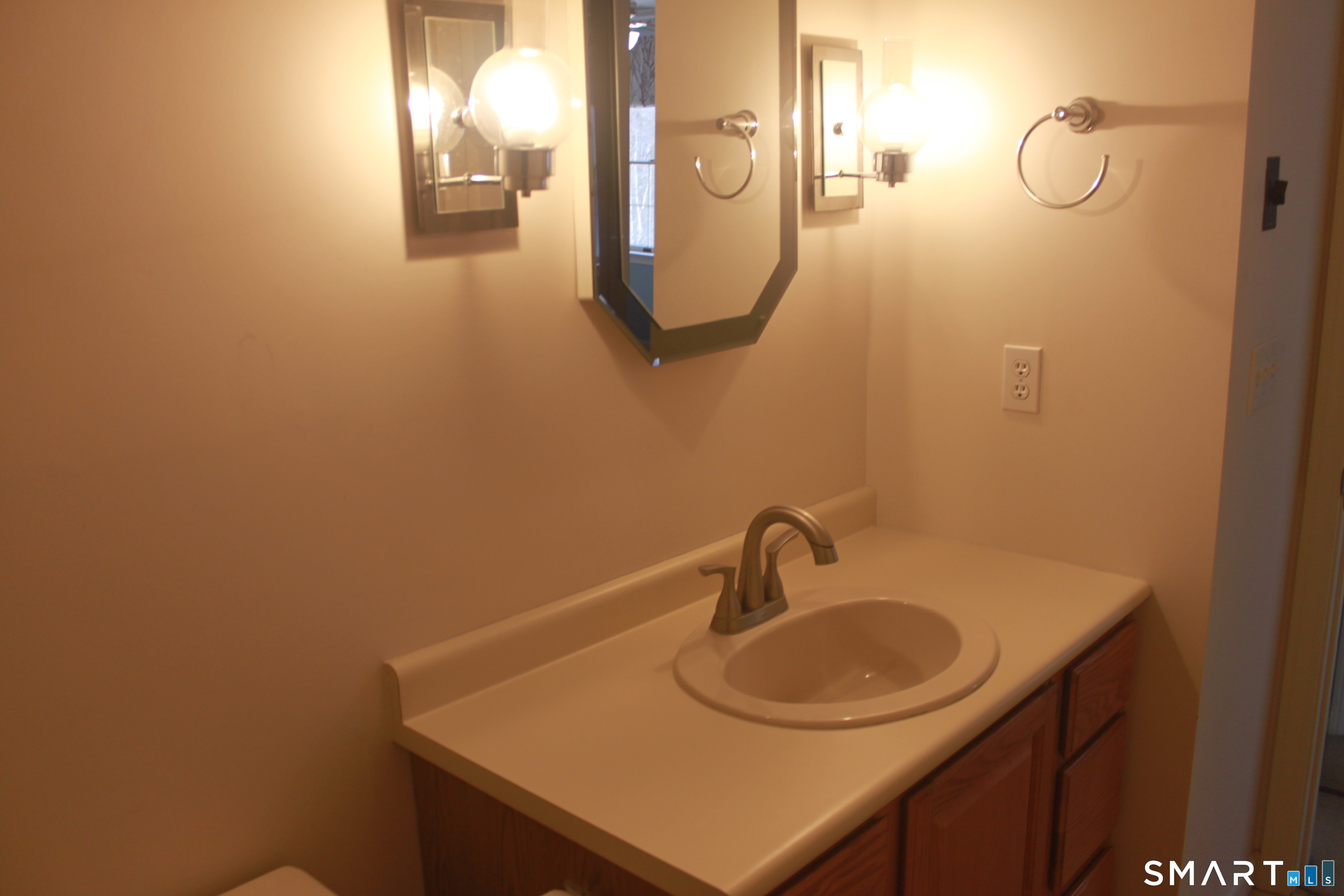 15 Downing Way, Unit 15 Suffield, CT 06078 - Photo 14 of 26 a bathroom with a sink vanity and mirror