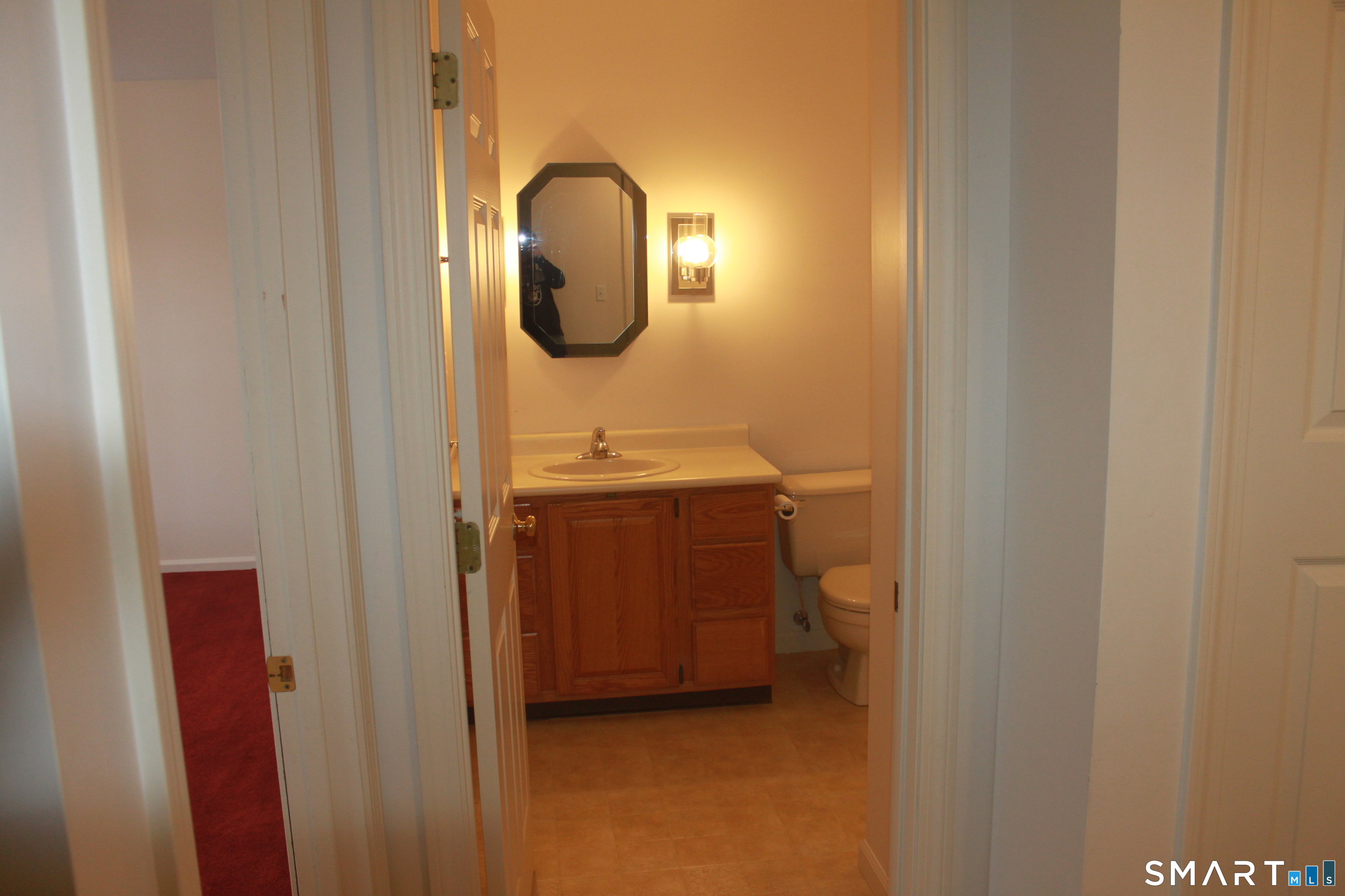 15 Downing Way, Unit 15 Suffield, CT 06078 - Photo 15 of 26 a bathroom with a sink and a mirror