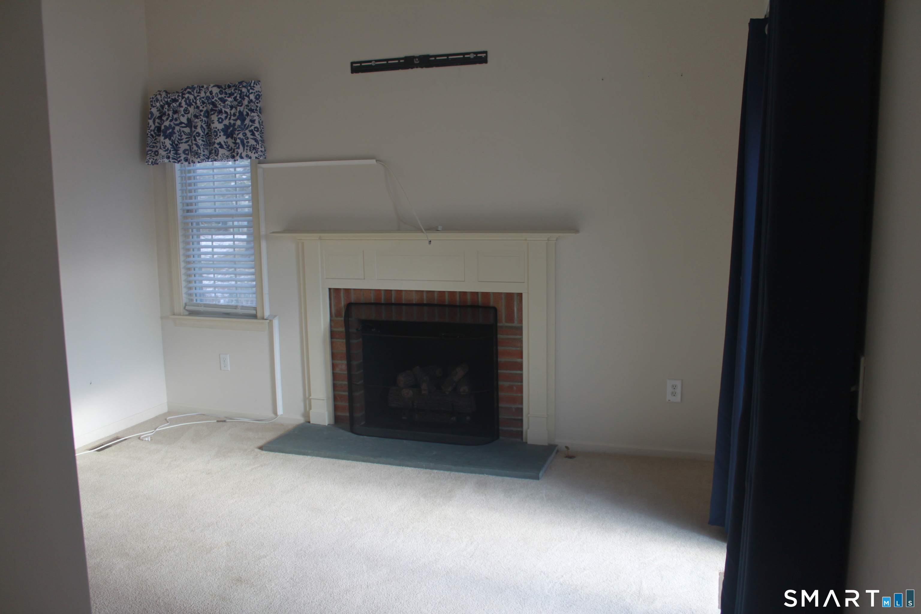 15 Downing Way, Unit 15 Suffield, CT 06078 - Photo 7 of 26 a view of an empty room with a fireplace