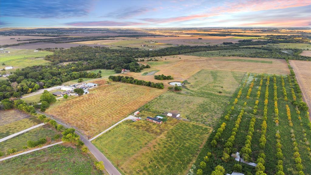 Tbd Holder Road Waxahachie, TX 75165 - Photo 13 of 24 Expansive rural property featuring diverse terrain, established tree rows, and a visible pond