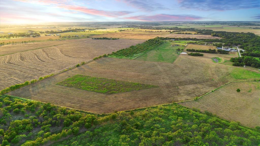 Tbd Holder Road Waxahachie, TX 75165 - Photo 17 of 24 Expansive rural landscape featuring a mix of cultivated fields, natural tree lines, and open land