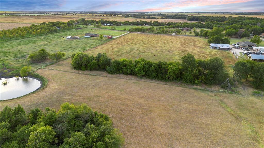 Tbd Holder Road Waxahachie, TX 75165 - Photo 20 of 24 Expansive rural landscape featuring a pond, open fields, and scattered trees