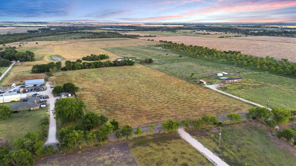 Tbd Holder Road Waxahachie, TX 75165 - Photo 22 of 24 Expansive acreage featuring multiple structures, an unpaved entry road, and numerous mature trees