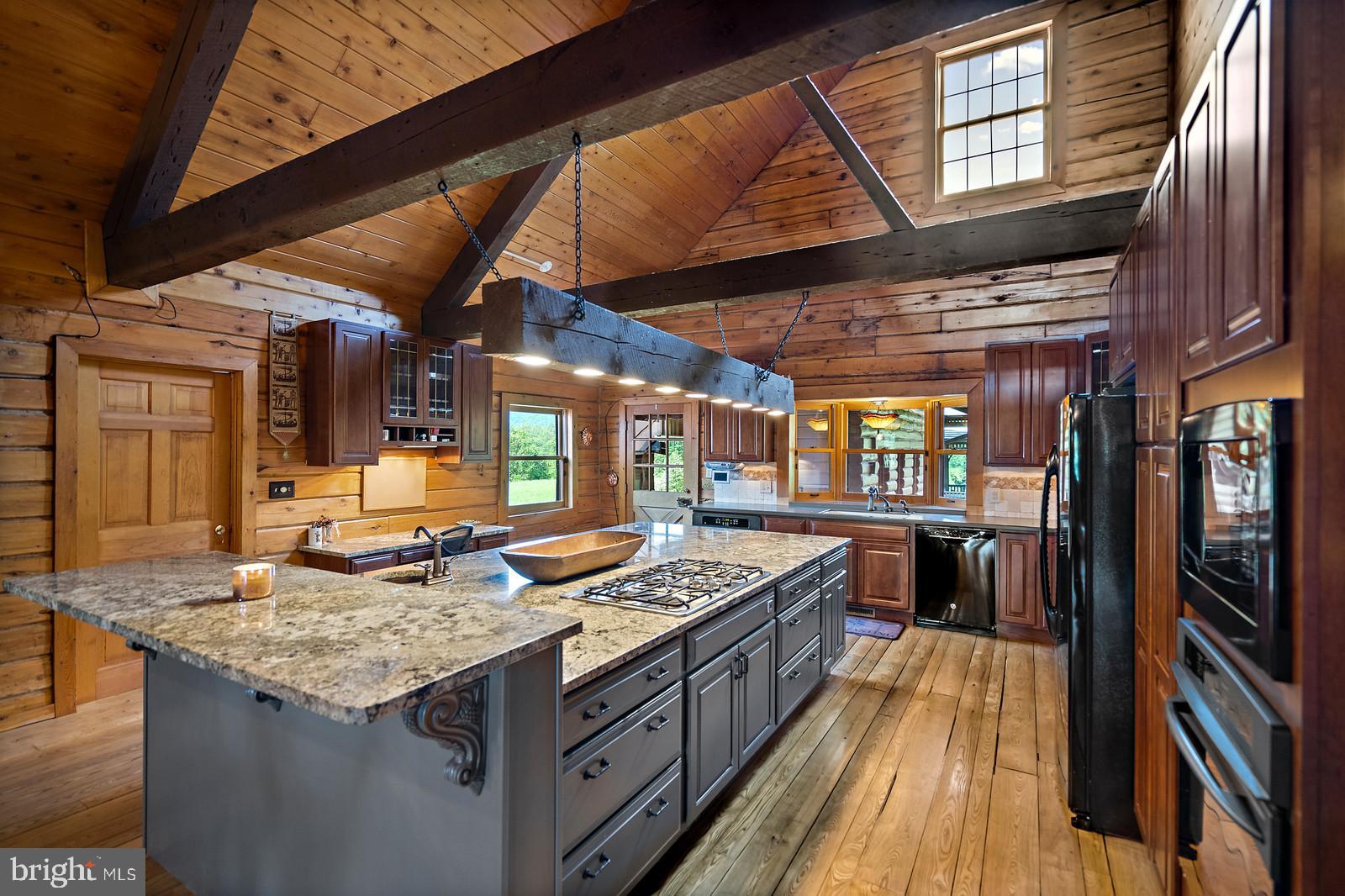 14249 Hume Road Hume, VA 22639 - Photo 10 of 48 a kitchen with a stove and a wooden cabinets