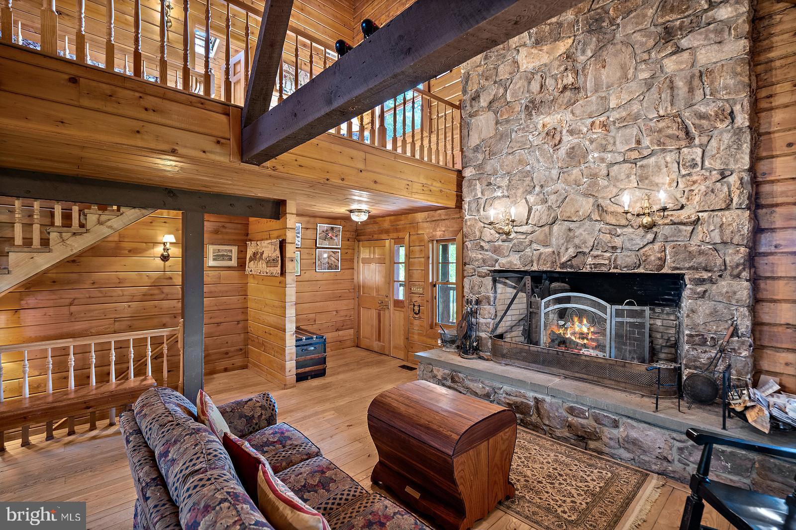 14249 Hume Road Hume, VA 22639 - Photo 15 of 48 a living room with furniture a fireplace and a floor to ceiling window