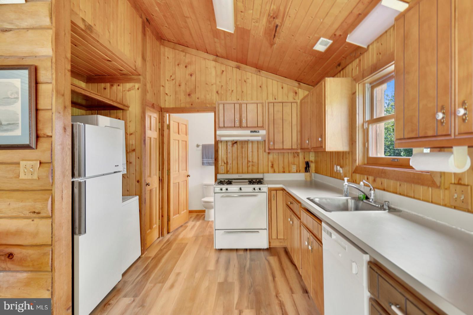 14249 Hume Road Hume, VA 22639 - Photo 42 of 48 a kitchen with a sink a counter top space stainless steel appliances and a large window