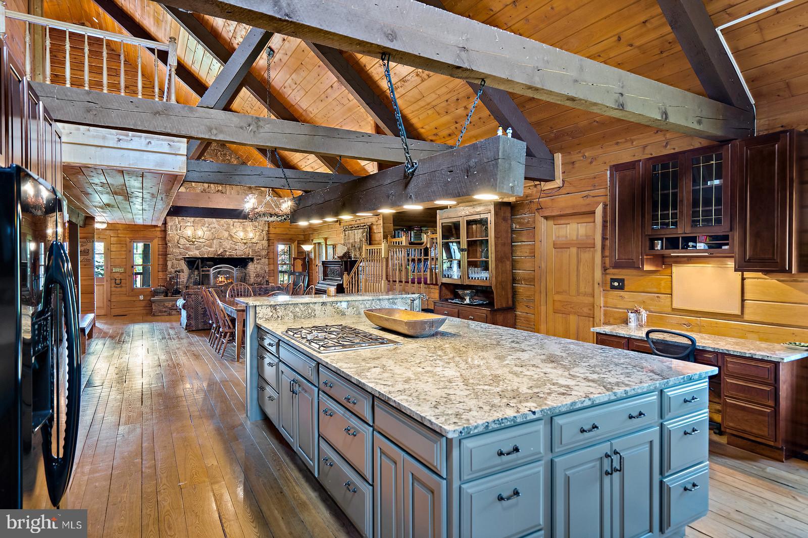 14249 Hume Road Hume, VA 22639 - Photo 8 of 48 a kitchen with kitchen island granite countertop wooden cabinets and granite counter tops