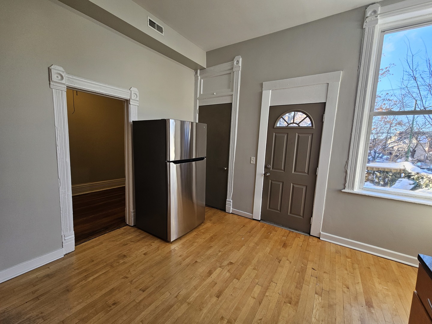 2000 South Ashland Avenue, Unit 1 Chicago, IL 60608 - Photo 11 of 23 a view of a kitchen with wooden floor refrigerator and a window