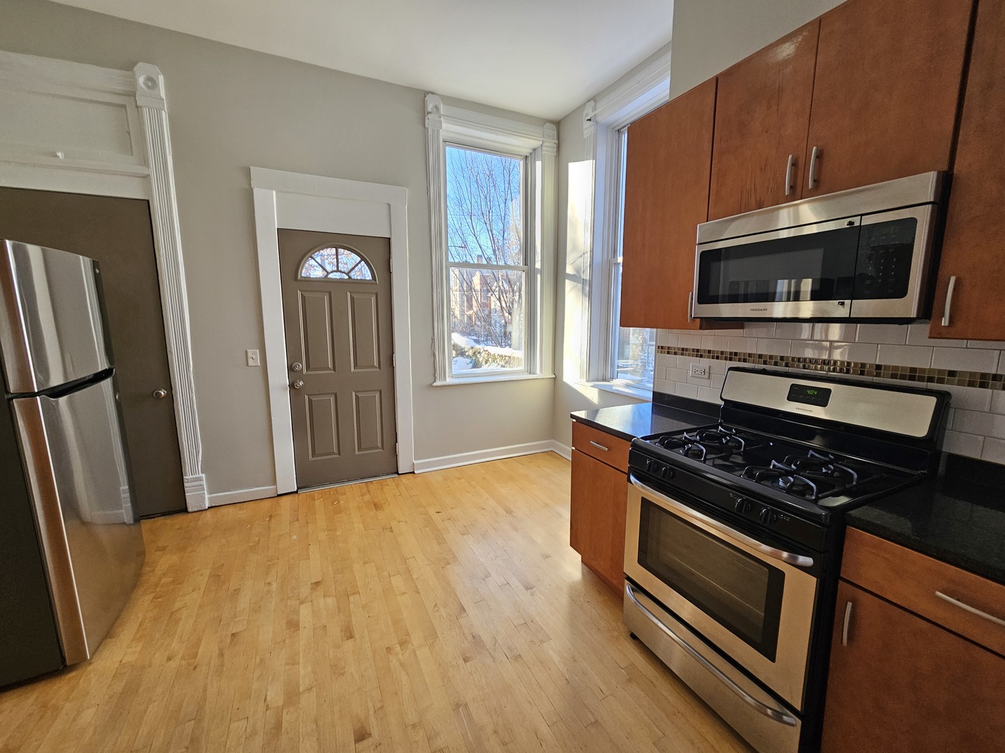 2000 South Ashland Avenue, Unit 1 Chicago, IL 60608 - Photo 12 of 23 a kitchen with stainless steel appliances a stove a microwave and a refrigerator