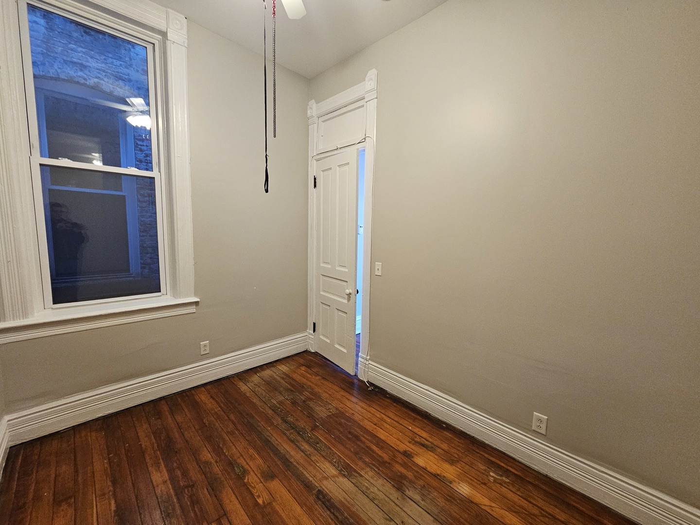 2000 South Ashland Avenue, Unit 1 Chicago, IL 60608 - Photo 13 of 23 a view of an empty room with wooden floor and a window
