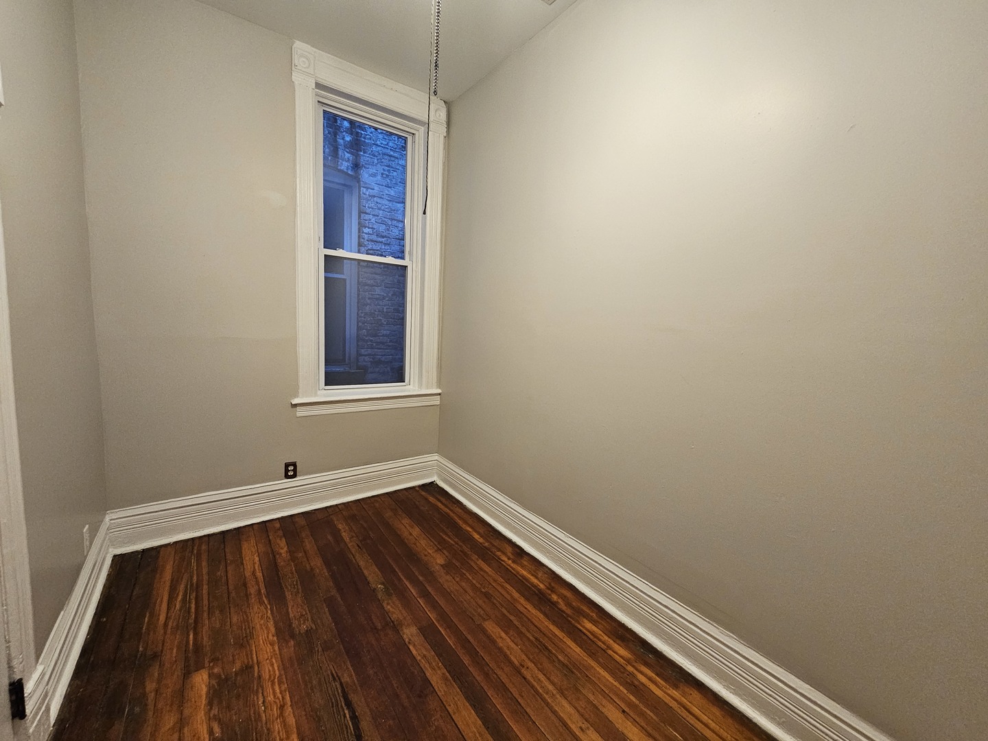 2000 South Ashland Avenue, Unit 1 Chicago, IL 60608 - Photo 17 of 23 a view of an empty room with wooden floor and a window