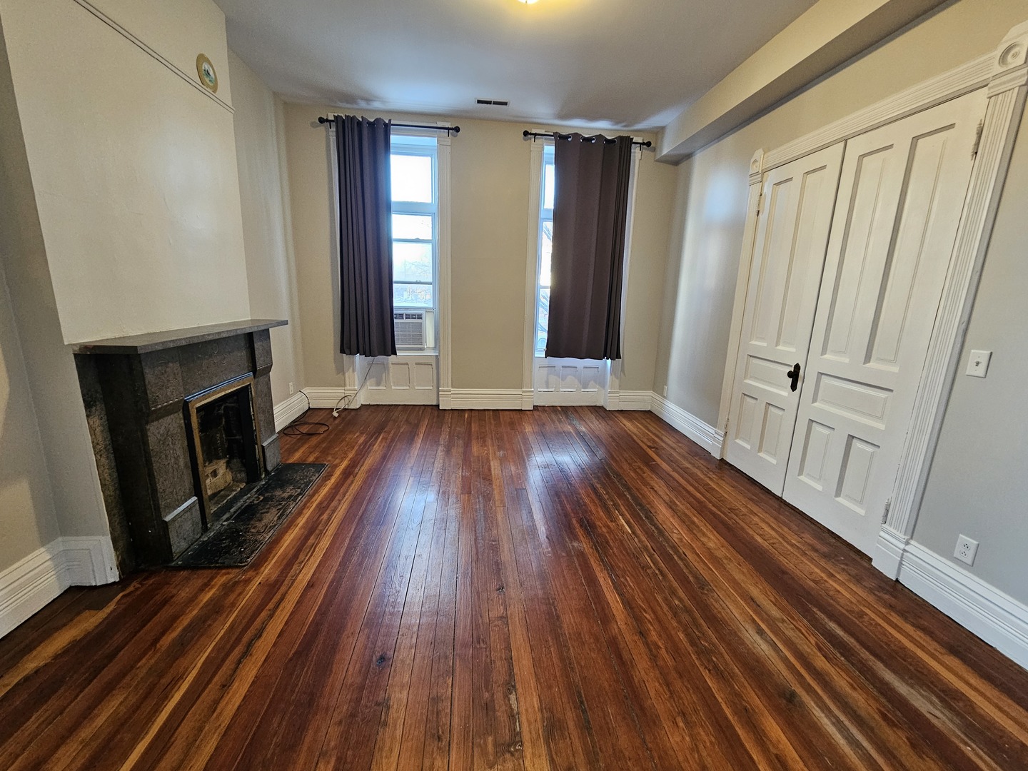 2000 South Ashland Avenue, Unit 1 Chicago, IL 60608 - Photo 4 of 23 a view of an empty room with wooden floor and a window