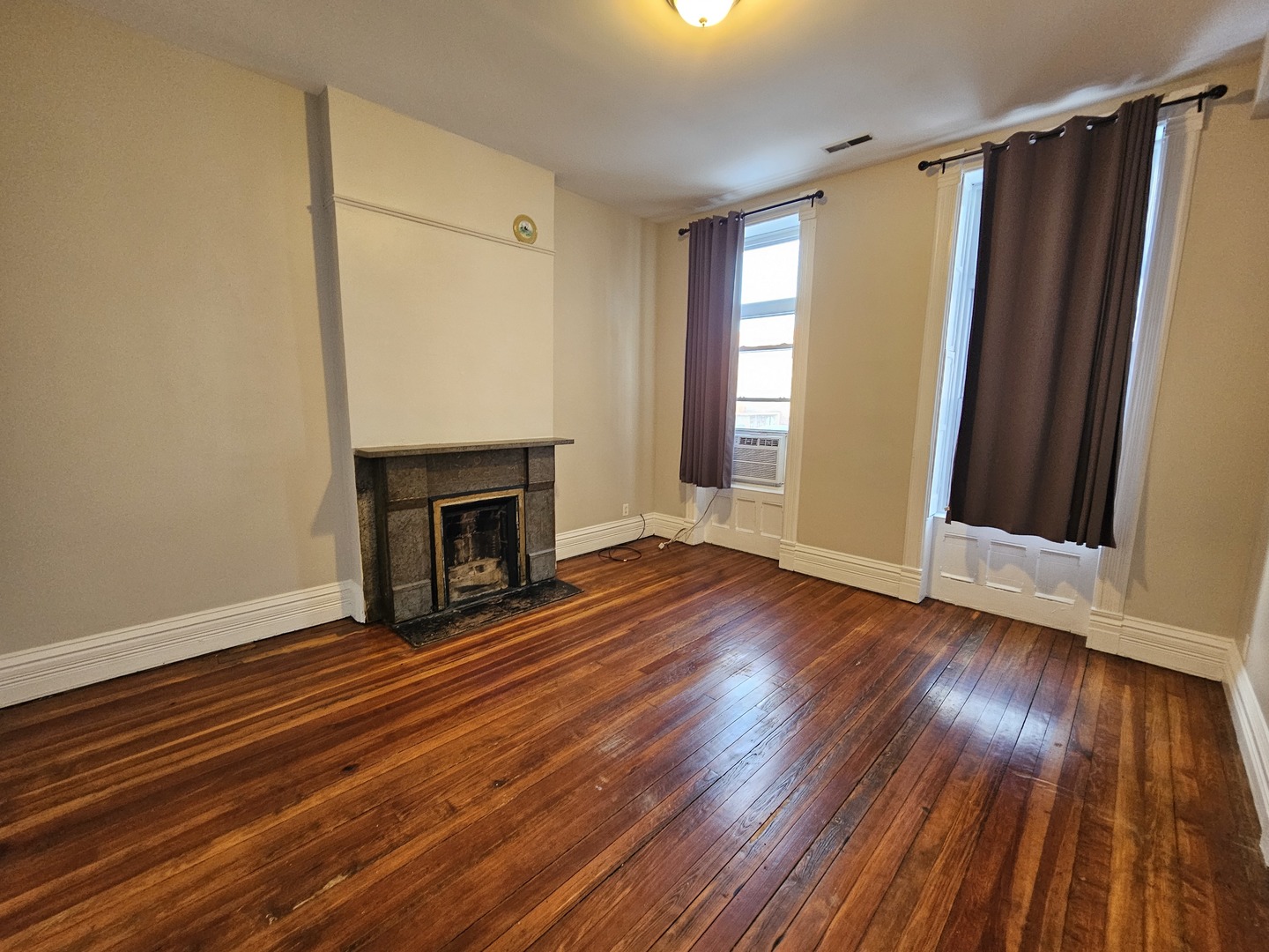 2000 South Ashland Avenue, Unit 1 Chicago, IL 60608 - Photo 5 of 23 a view of an empty room with wooden floor and a window