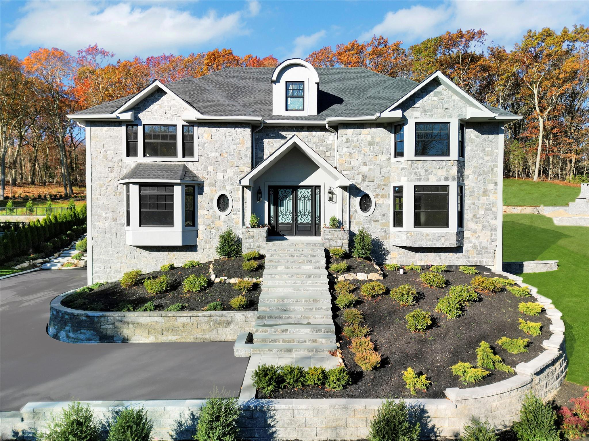 French country style house with a shingled roof, a front yard, and french doors