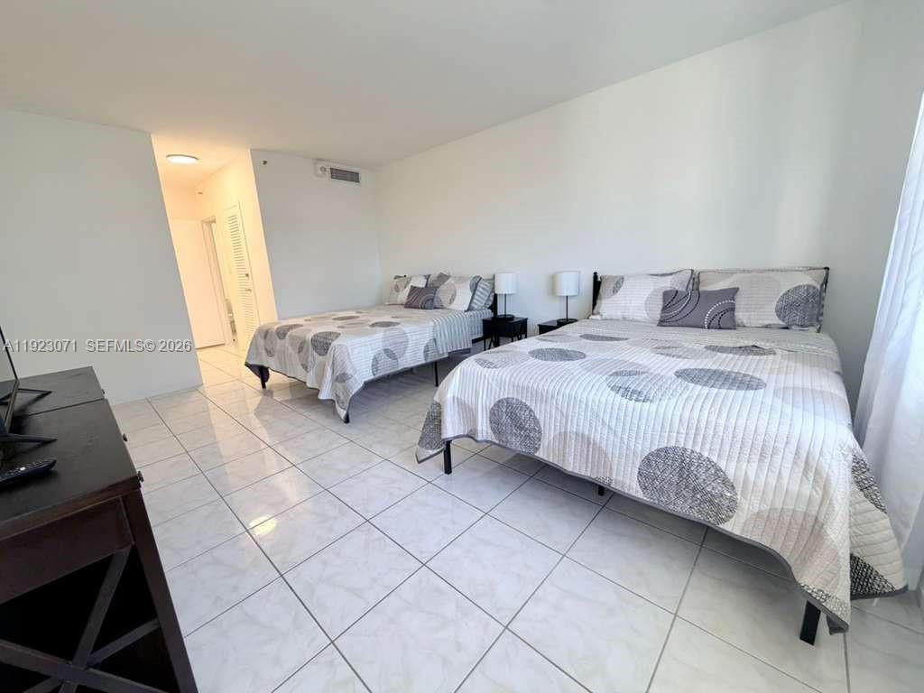 100 Lincoln Road, Unit 541 Miami Beach, FL 33139 - Photo 12 of 17 a bedroom with a bed and a window