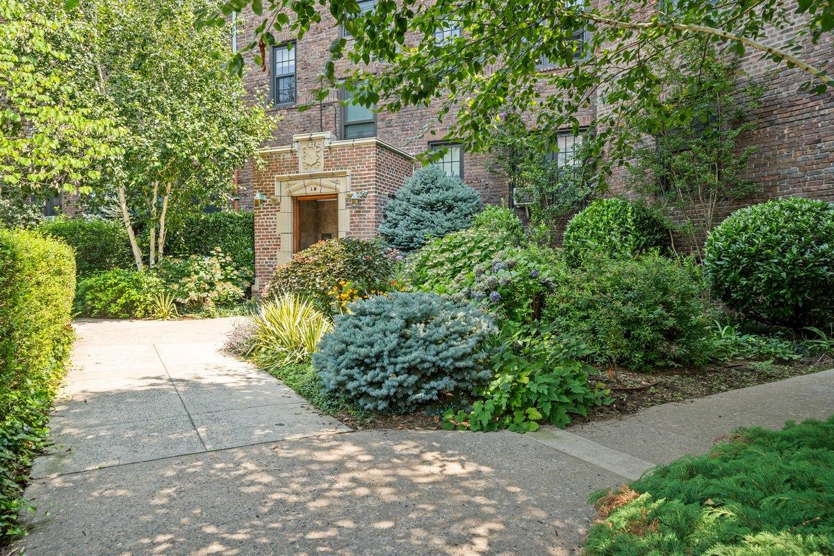 525 West 238th Street, Unit 1L Bronx, NY 10463 - Photo 1 of 20 a view of a building with garden