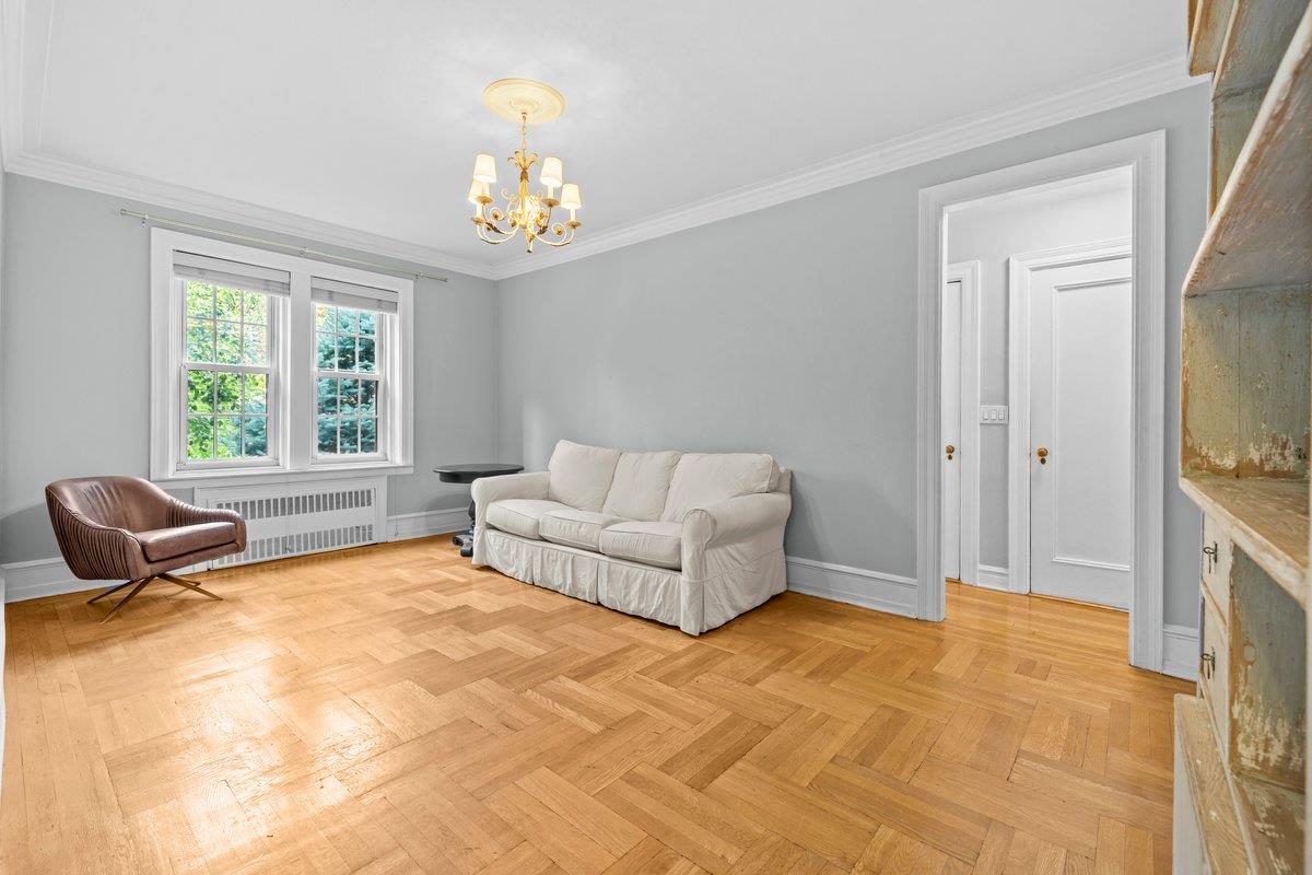 525 West 238th Street, Unit 1L Bronx, NY 10463 - Photo 10 of 20 a bedroom with a bed and a chandelier