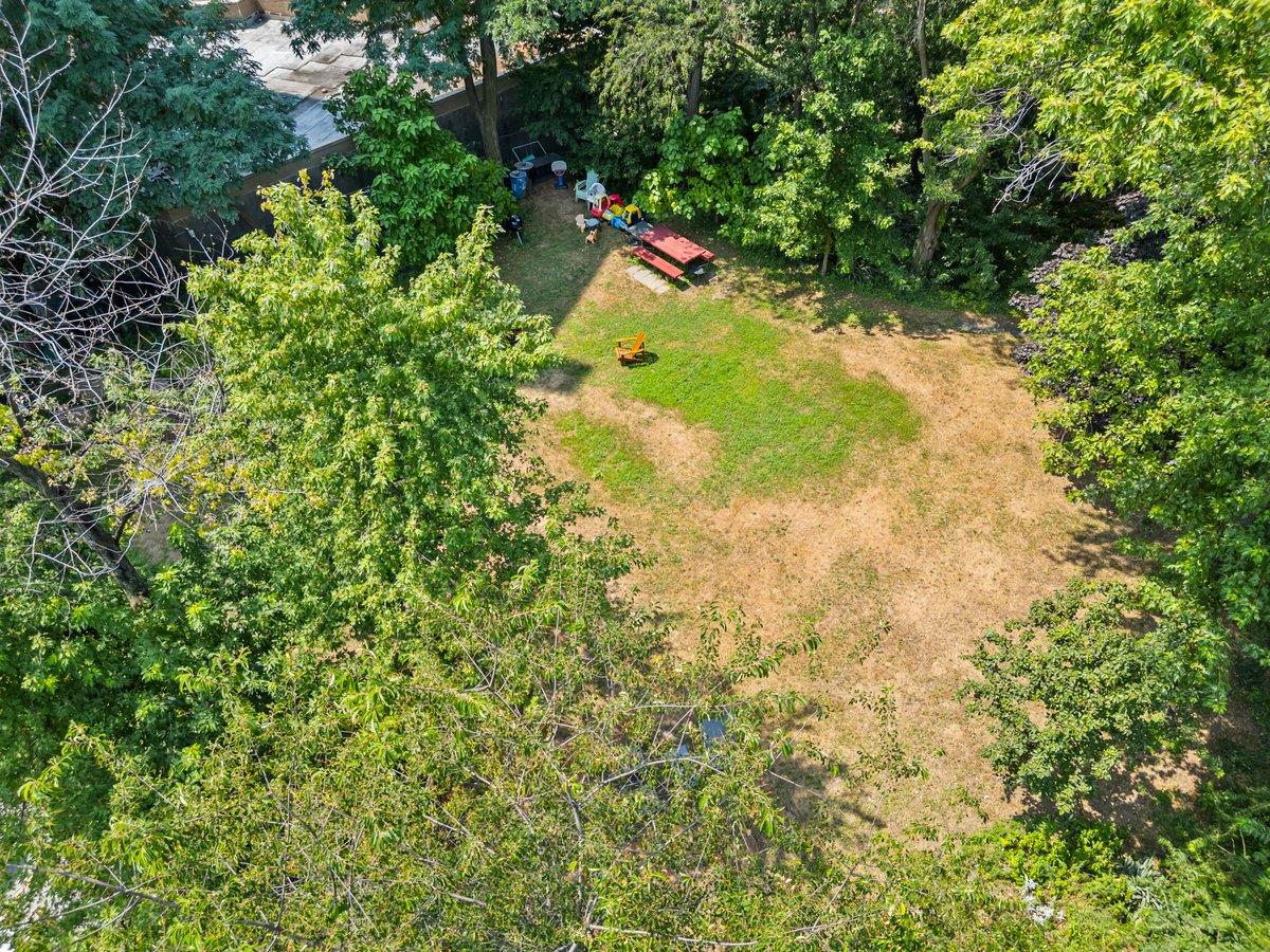 525 West 238th Street, Unit 1L Bronx, NY 10463 - Photo 19 of 20 a backyard of a house with a yard and potted plants