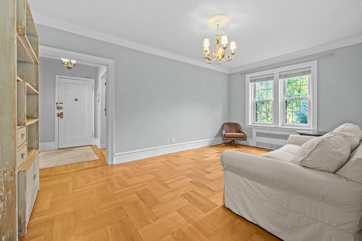 525 West 238th Street, Unit 1L Bronx, NY 10463 - Photo 9 of 20 a spacious bedroom with a bed and a chandelier