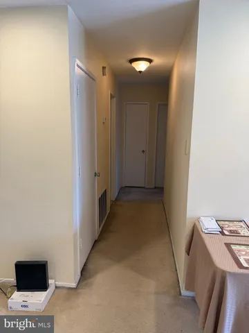 a view of a hallway to a room with a projector