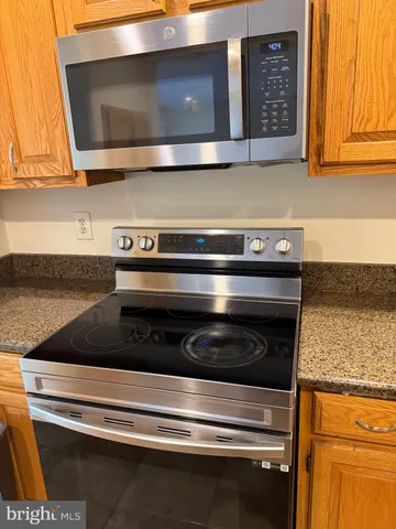 a stove top oven sitting inside of a kitchen