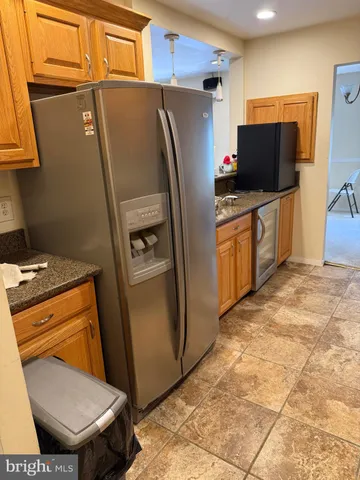 a kitchen with stainless steel appliances a refrigerator and a stove