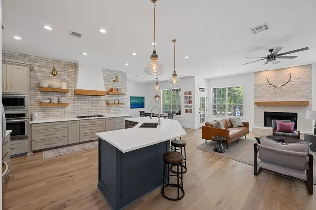 a kitchen with a sink stainless steel appliances and white cabinets