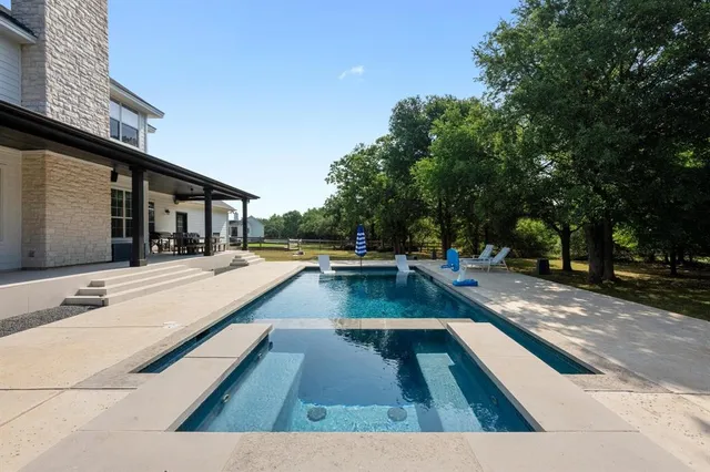 a view of swimming pool with lounge chair