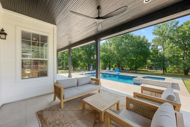 a outdoor living space with patio furniture and a large window