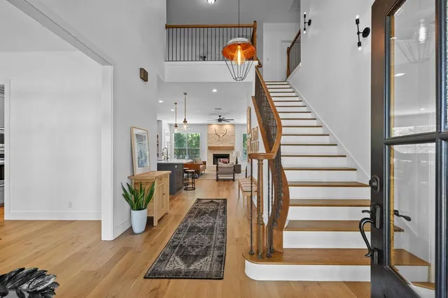 a view of entryway and hall with wooden floor